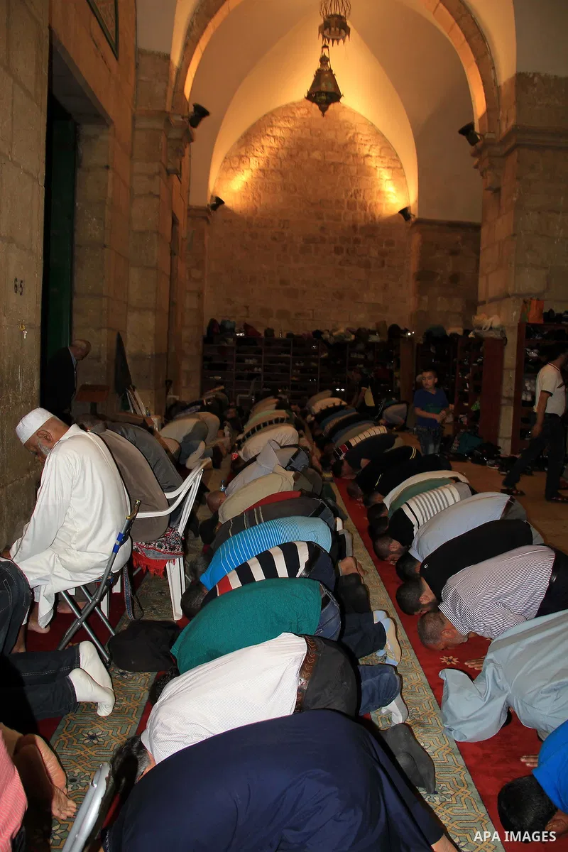 Palestinian Muslim worshippers perform "Taraweeh", nightly prayer of the month of Ramadan, in front of the Dome of the Rock mosque, in Jerusalem's old city on June 28, 2016. Ramadan is sacred to Muslims because it is dur...
