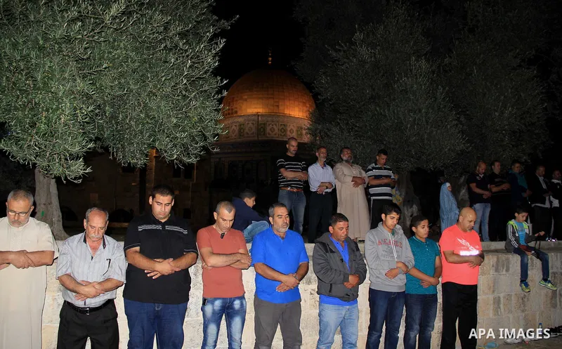 Palestinian Muslim worshippers perform "Taraweeh", nightly prayer of the month of Ramadan, in front of the Dome of the Rock mosque, in Jerusalem's old city on June 28, 2016. Ramadan is sacred to Muslims because it is dur...