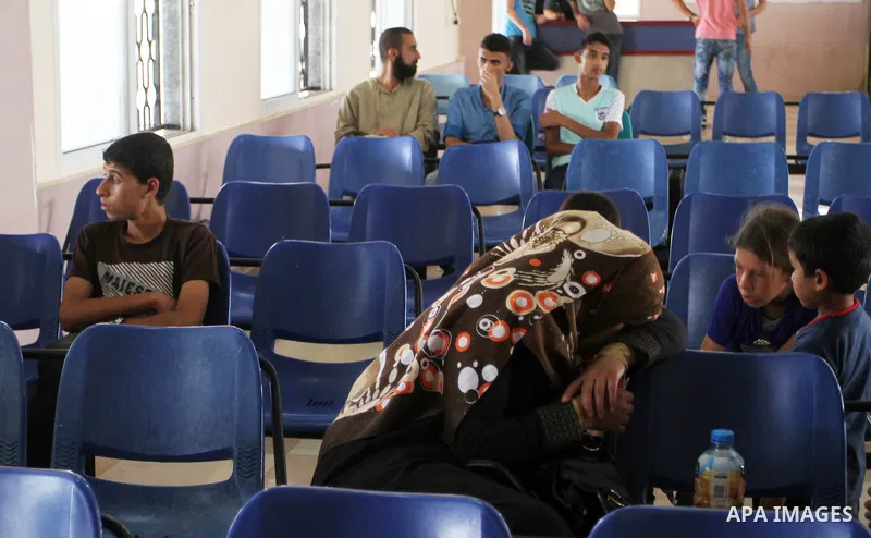 Palestinians wait for a travel permit to cross into Egypt through the Rafah border crossing after it was opened by Egyptian authorities for five days, in the southern Gaza Strip June 29, 2016. Photo by Abed Rahim Khatib