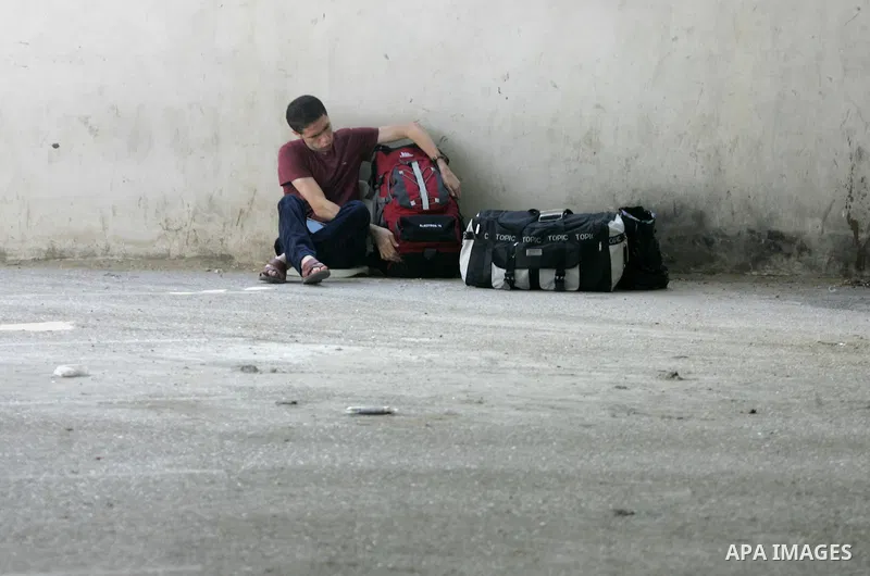 A Palestinian man waits for a travel permit to cross into Egypt through the Rafah border crossing after it was opened by Egyptian authorities for five days, in the southern Gaza Strip June 29, 2016. Photo by Abed Rahim K...