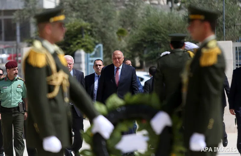 Egyptian Foreign Minister Sameh Shoukry prepares to lay a wreath of flowers on the tomb of late Palestinian leader Yasser Arafat during a visit to the Palestinian authority headquarters in the West Bank city of Ramallah...