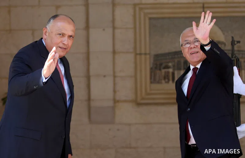Secretary General of the Palestinian Presidency Tayeb Abdel Rahim welcomes Egyptian Foreign Minister Sameh Shoukry during a visit to the Palestinian authority headquarters in the West Bank city of Ramallah on June 29, 20...