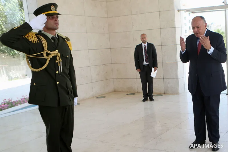 Egyptian Foreign Minister Sameh Shoukry lays a wreath of flowers on the tomb of late Palestinian leader Yasser Arafat during a visit to the Palestinian authority headquarters in the West Bank city of Ramallah on June 29,...