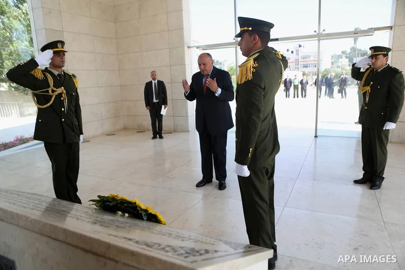 Egyptian Foreign Minister Sameh Shoukry lays a wreath of flowers on the tomb of late Palestinian leader Yasser Arafat during a visit to the Palestinian authority headquarters in the West Bank city of Ramallah on June 29,...