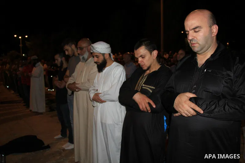 Palestinian Muslim worshippers perform "Taraweeh", nightly prayer of the month of Ramadan, in front of the Dome of the Rock mosque, in Jerusalem's old city on June 29, 2016. Ramadan is sacred to Muslims because it is dur...