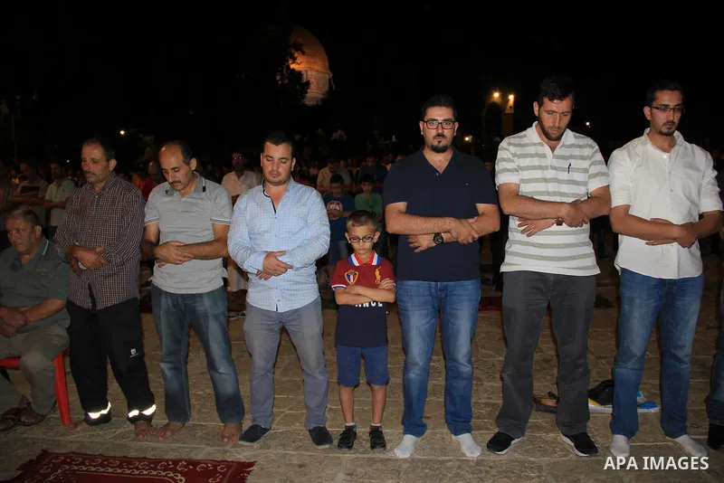 Palestinian Muslim worshippers perform "Taraweeh", nightly prayer of the month of Ramadan, in front of the Dome of the Rock mosque, in Jerusalem's old city on June 29, 2016. Ramadan is sacred to Muslims because it is dur...