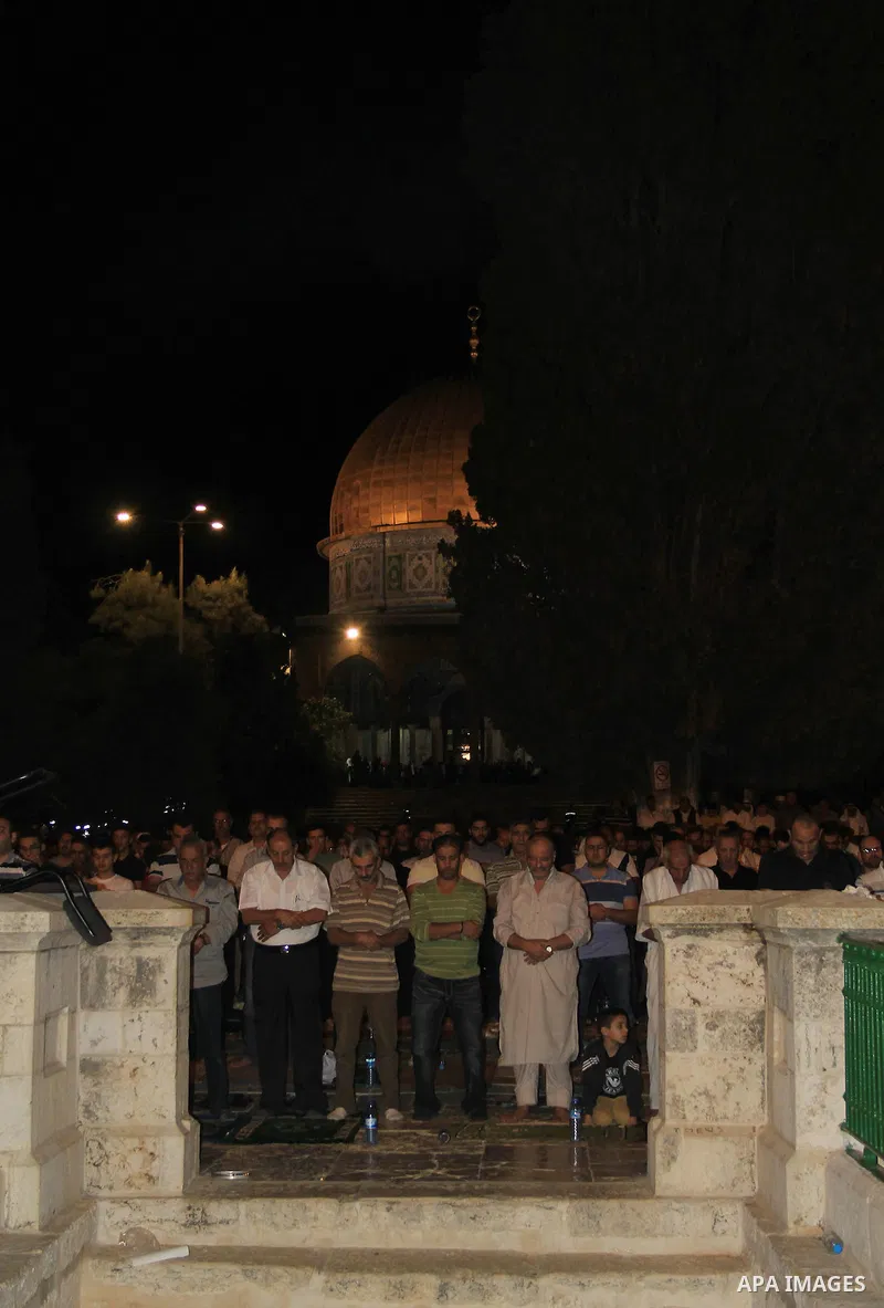 Palestinian Muslim worshippers perform "Taraweeh", nightly prayer of the month of Ramadan, in front of the Dome of the Rock mosque, in Jerusalem's old city on June 29, 2016. Ramadan is sacred to Muslims because it is dur...
