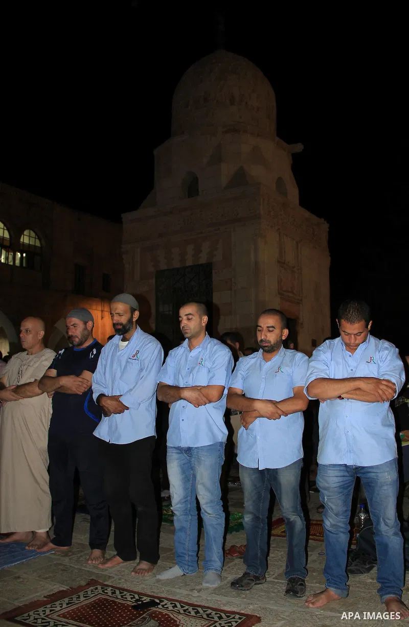 Palestinian Muslim worshippers perform "Taraweeh", nightly prayer of the month of Ramadan, in front of the Dome of the Rock mosque, in Jerusalem's old city on June 29, 2016. Ramadan is sacred to Muslims because it is dur...