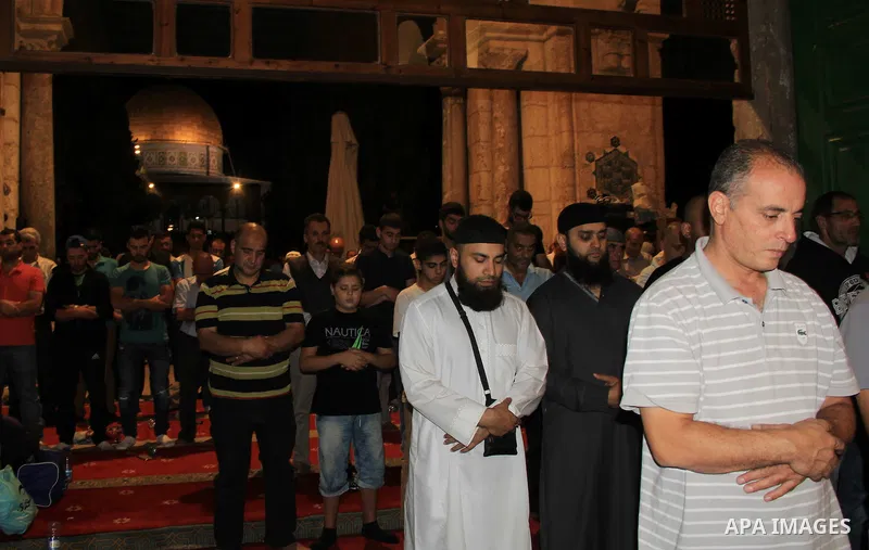 Palestinian Muslim worshippers perform "Taraweeh", nightly prayer of the month of Ramadan, in front of the Dome of the Rock mosque, in Jerusalem's old city on June 29, 2016. Ramadan is sacred to Muslims because it is dur...