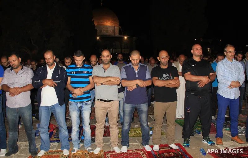 Palestinian Muslim worshippers perform "Taraweeh", nightly prayer of the month of Ramadan, in front of the Dome of the Rock mosque, in Jerusalem's old city on June 29, 2016. Ramadan is sacred to Muslims because it is dur...