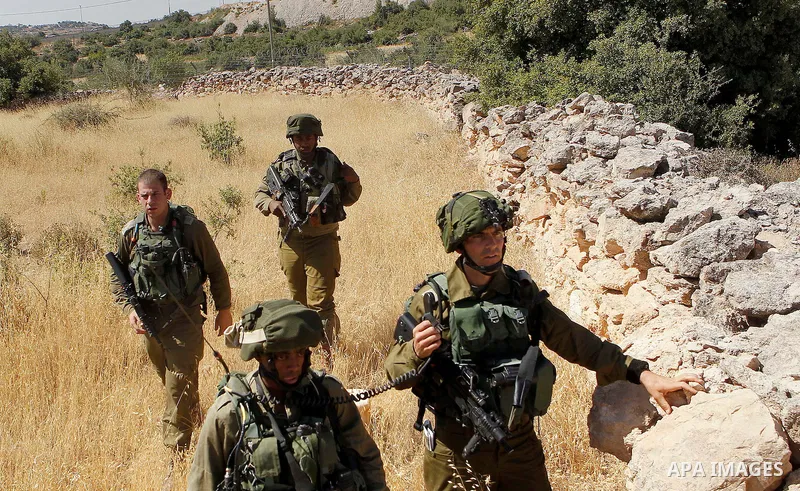 Israeli security forces gather near the scene of what the Israeli military said was an attack by Palestinian in the Jewish settlement of Kiryat Arba near the West Bank city of Hebron 30 June 2016. Israeli army said the P...