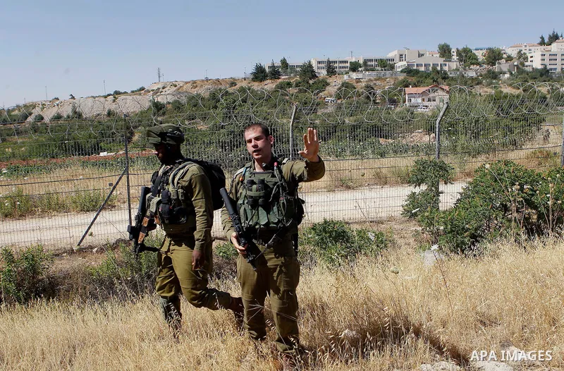 Israeli security forces gather near the scene of what the Israeli military said was an attack by Palestinian in the Jewish settlement of Kiryat Arba near the West Bank city of Hebron 30 June 2016. Israeli army said the P...