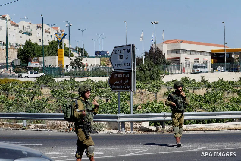 Israeli security forces gather near the scene of what the Israeli military said was an attack by Palestinian in the Jewish settlement of Kiryat Arba near the West Bank city of Hebron 30 June 2016. Israeli army said the P...