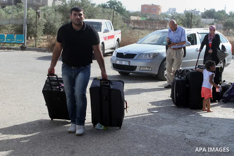 Palestinians wait for a travel permit to cross into Egypt through the Rafah border crossing after it was opened by Egyptian authorities for five days, in the southern Gaza Strip June 30, 2016. Photo by Abed Rahim Khatib