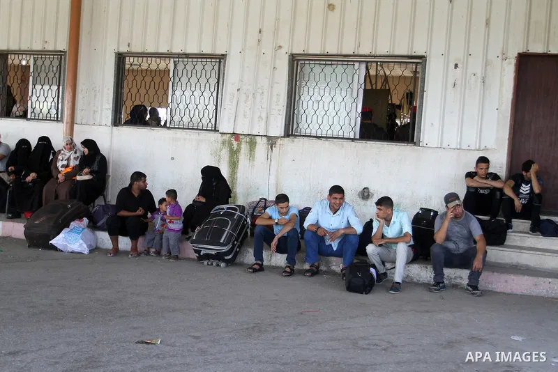 Palestinians wait for a travel permit to cross into Egypt through the Rafah border crossing after it was opened by Egyptian authorities for five days, in the southern Gaza Strip June 30, 2016. Photo by Abed Rahim Khatib