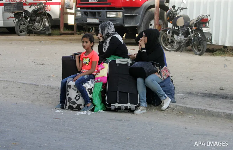 Palestinians wait for a travel permit to cross into Egypt through the Rafah border crossing after it was opened by Egyptian authorities for five days, in the southern Gaza Strip June 30, 2016. Photo by Abed Rahim Khatib