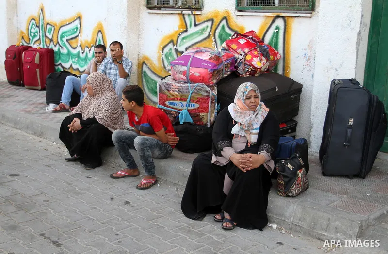 Palestinians wait for a travel permit to cross into Egypt through the Rafah border crossing after it was opened by Egyptian authorities for five days, in the southern Gaza Strip June 30, 2016. Photo by Abed Rahim Khatib