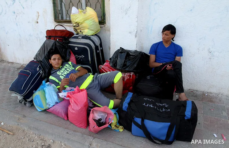 Palestinians wait for a travel permit to cross into Egypt through the Rafah border crossing after it was opened by Egyptian authorities for five days, in the southern Gaza Strip June 30, 2016. Photo by Abed Rahim Khatib