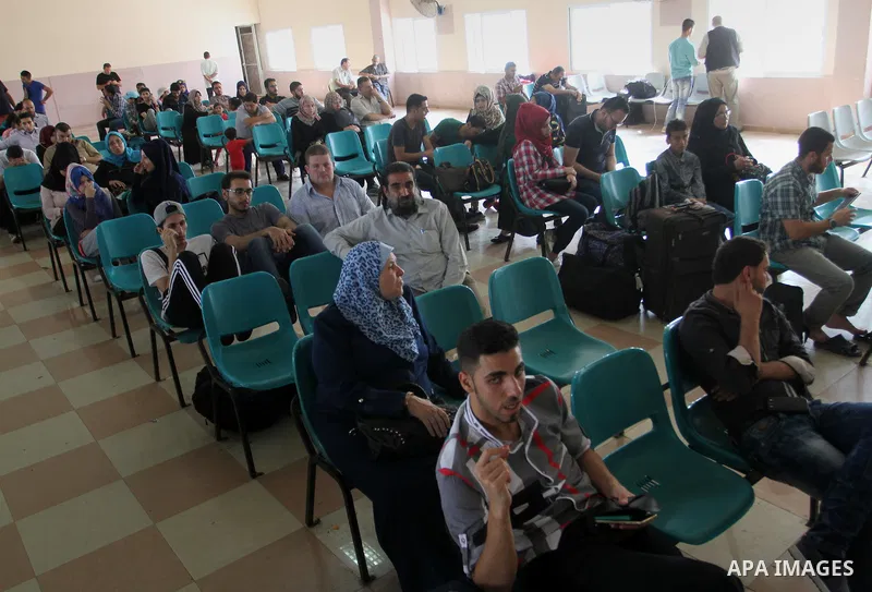 Palestinians wait for a travel permit to cross into Egypt through the Rafah border crossing after it was opened by Egyptian authorities for five days, in the southern Gaza Strip June 30, 2016. Photo by Abed Rahim Khatib