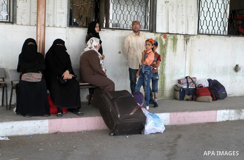 Palestinians wait for a travel permit to cross into Egypt through the Rafah border crossing after it was opened by Egyptian authorities for five days, in the southern Gaza Strip June 30, 2016. Photo by Abed Rahim Khatib