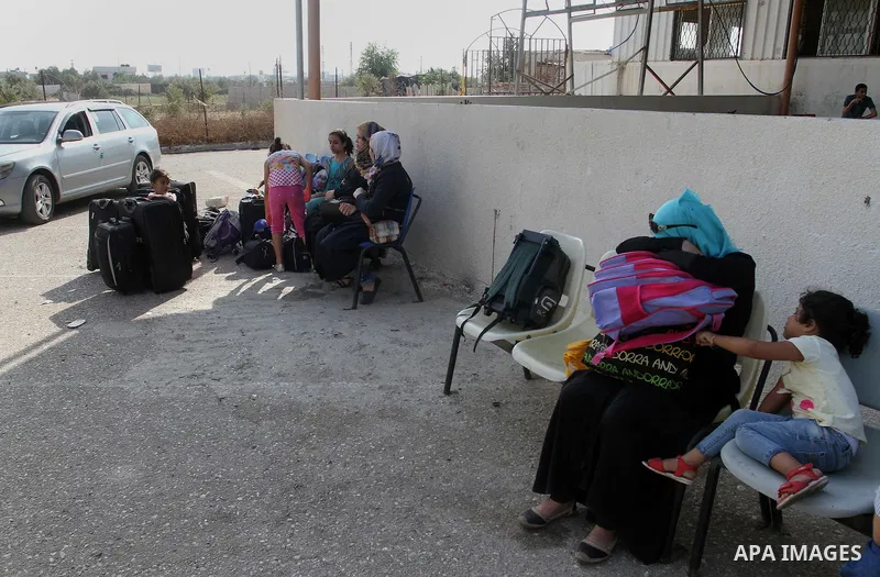 Palestinians wait for a travel permit to cross into Egypt through the Rafah border crossing after it was opened by Egyptian authorities for five days, in the southern Gaza Strip June 30, 2016. Photo by Abed Rahim Khatib