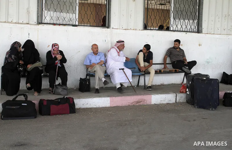 Palestinians wait for a travel permit to cross into Egypt through the Rafah border crossing after it was opened by Egyptian authorities for five days, in the southern Gaza Strip June 30, 2016. Photo by Abed Rahim Khatib