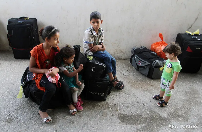 Palestinians wait for a travel permit to cross into Egypt through the Rafah border crossing after it was opened by Egyptian authorities for five days, in the southern Gaza Strip June 30, 2016. Photo by Abed Rahim Khatib
