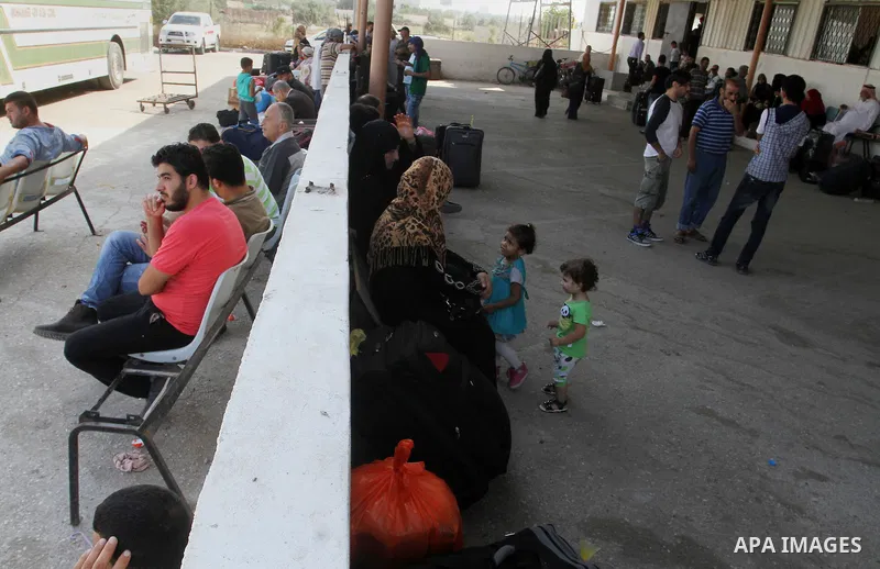 Palestinians wait for a travel permit to cross into Egypt through the Rafah border crossing after it was opened by Egyptian authorities for five days, in the southern Gaza Strip June 30, 2016. Photo by Abed Rahim Khatib