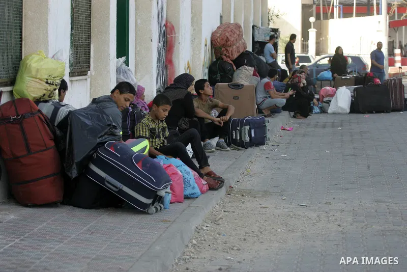 Palestinians wait for a travel permit to cross into Egypt through the Rafah border crossing after it was opened by Egyptian authorities for five days, in the southern Gaza Strip June 30, 2016. Photo by Abed Rahim Khatib