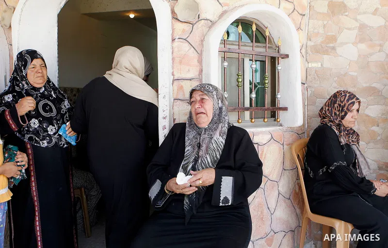 The family of Palestinian Mohammed Nasser Tarayra, who stabbed to death an Israeli teen in a Jewish settlement in the occupied West Bank on June 30,2016 is seen outside their family home in the village of Bani Naim, near...