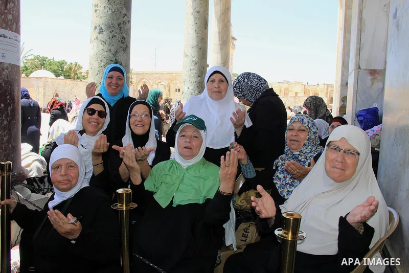 Palestinian women pray outside the Dome of the Rock in Jerusalem's Al-Aqsa mosque compound during the last Friday prayers of the holy Muslim fasting month of Ramadan on July 1, 2016. Photo by Mahfouz Abu Turk