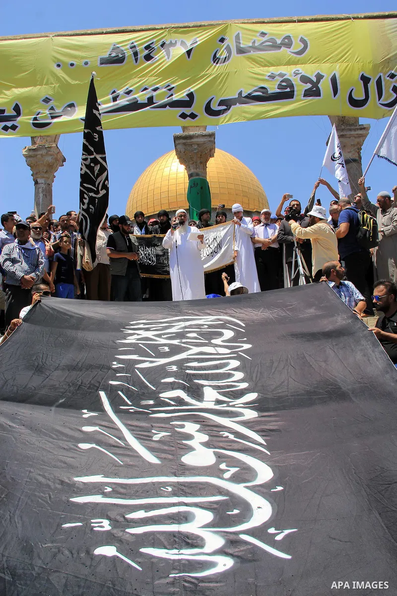 Supporters of Hizb ut-Tahrir take part during a rally calling for return of Islamic Caliphate outside the Dome of the Rock in Jerusalem's Al-Aqsa mosque compound following Friday prayers of the holy Muslim fasting month...