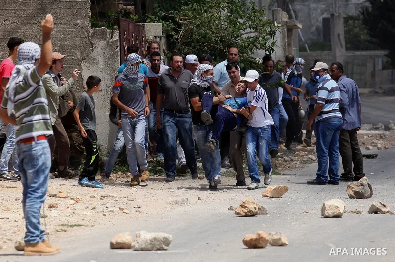 A wounded Palestinian is evacuated by protesters during clashes following a demonstration against the expropriation of Palestinian land by Israel, on July 01, 2016 in the village of Kfar Qaddum, near Nablus, in the occup...