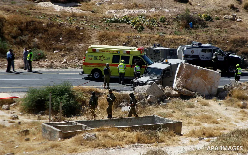 Israeli security forces gather at the scene following a shooting on an Israeli car near the West Bank city of Hebron July 1, 2016. Photo by Wisam Hashlamoun