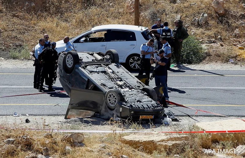 Israeli security forces gather at the scene following a shooting on an Israeli car near the West Bank city of Hebron July 1, 2016. Photo by Wisam Hashlamoun
