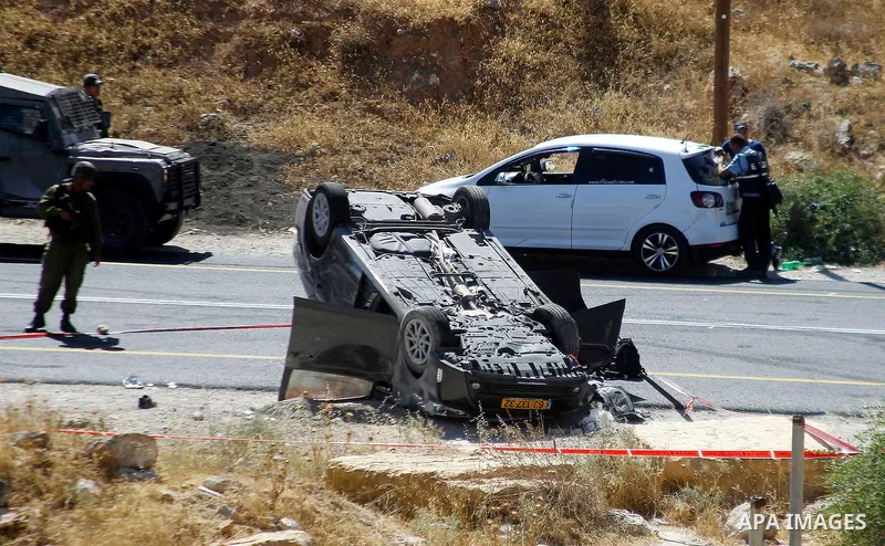 Israeli security forces gather at the scene following a shooting on an Israeli car near the West Bank city of Hebron July 1, 2016. Photo by Wisam Hashlamoun