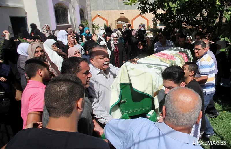 Mourners carry the coffin of Sondos al-Basha, a Palestinian woman who was killed in the Istanbul airport attack blamed on the Islamic State (IS) group on June 28, during her funeral in the West Bank town of Qalqilyah on...