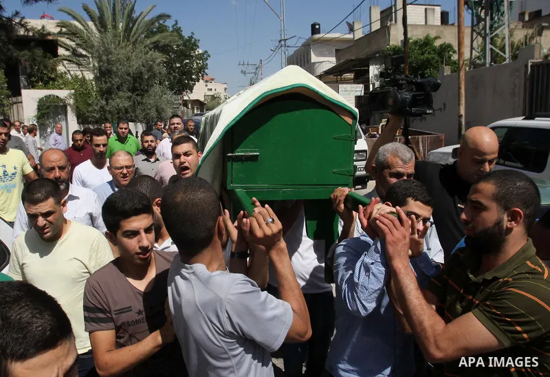 Mourners carry the coffin of Sondos al-Basha, a Palestinian woman who was killed in the Istanbul airport attack blamed on the Islamic State (IS) group on June 28, during her funeral in the West Bank town of Qalqilyah on...