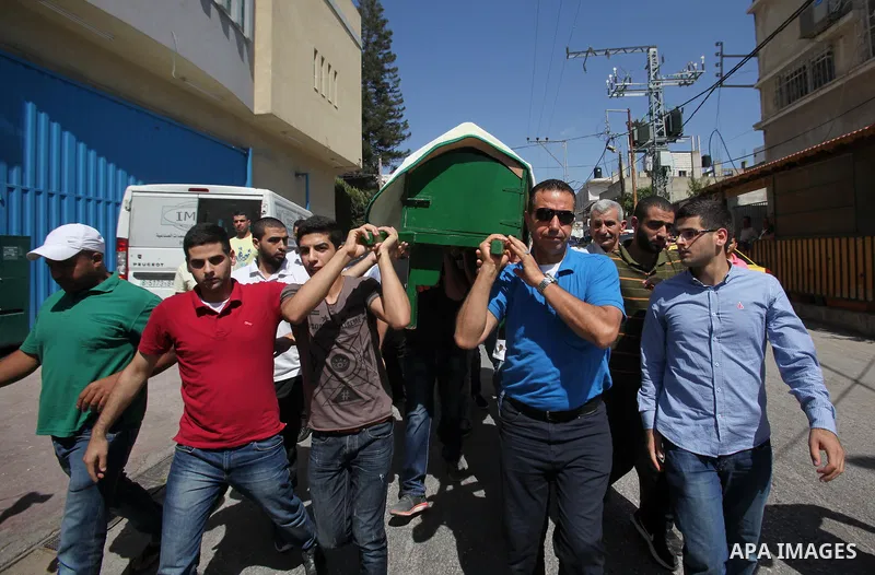Mourners carry the coffin of Sondos al-Basha, a Palestinian woman who was killed in the Istanbul airport attack blamed on the Islamic State (IS) group on June 28, during her funeral in the West Bank town of Qalqilyah on...