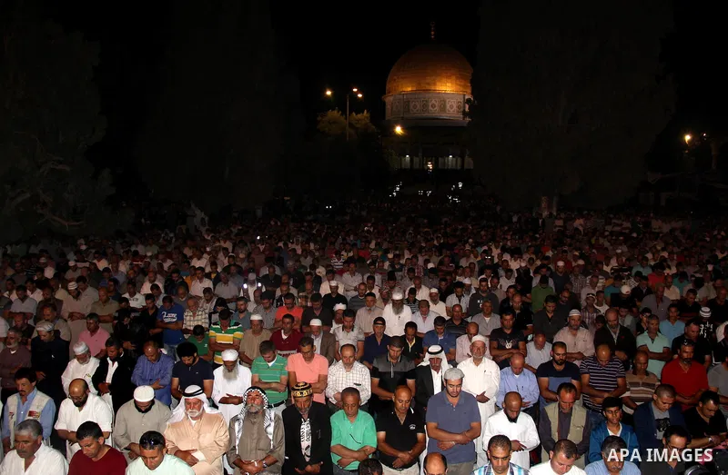 Palestinian muslim worshipers take part in Laylat Al Qadr prayers or Night of Power, in which the Muslim holy book of Koran was revealed to Prophet Mohammad by Allah on the 27th day of the holy fasting month of Ramadan i...