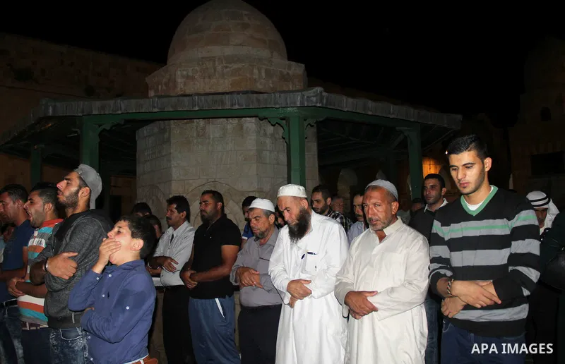 Palestinian muslim worshipers take part in Laylat Al Qadr prayers or Night of Power, in which the Muslim holy book of Koran was revealed to Prophet Mohammad by Allah on the 27th day of the holy fasting month of Ramadan i...