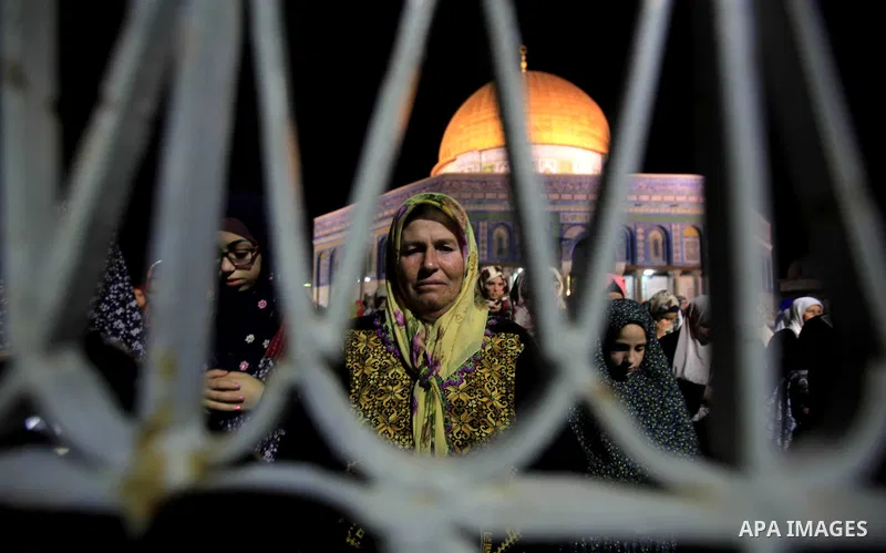Palestinian muslim worshipers take part in Laylat Al Qadr prayers or Night of Power, in which the Muslim holy book of Koran was revealed to Prophet Mohammad by Allah on the 27th day of the holy fasting month of Ramadan i...