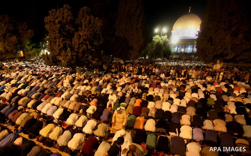Palestinian muslim worshipers take part in Laylat Al Qadr prayers or Night of Power, in which the Muslim holy book of Koran was revealed to Prophet Mohammad by Allah on the 27th day of the holy fasting month of Ramadan i...