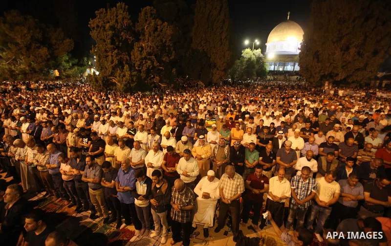 Palestinian muslim worshipers take part in Laylat Al Qadr prayers or Night of Power, in which the Muslim holy book of Koran was revealed to Prophet Mohammad by Allah on the 27th day of the holy fasting month of Ramadan i...