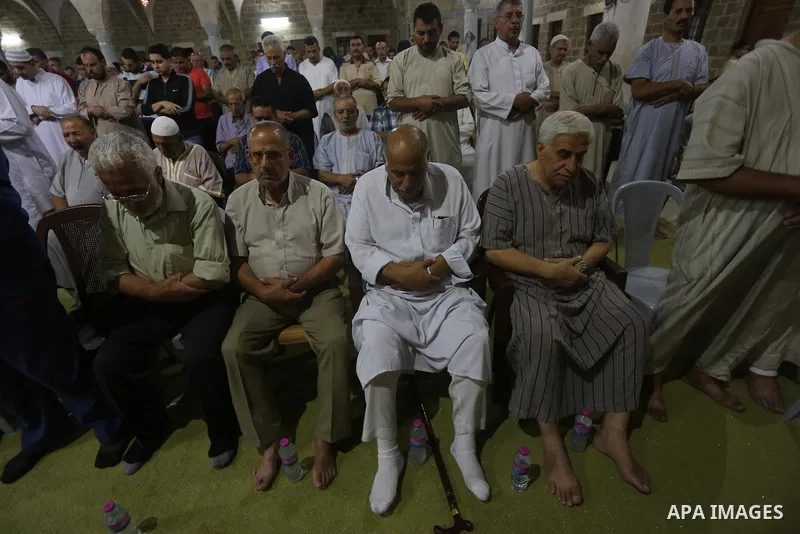 Palestinian Muslim worshippers pray overnight on July 2, 2016 at a Mosque in Gaza city on the occasion of Laylat al-Qadr which falls on the 27th day of the fasting month of Ramadan. Laylat al-Qadr, or Night of Destiny, m...