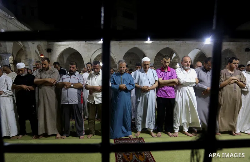 Palestinian Muslim worshippers pray overnight on July 2, 2016 at a Mosque in Gaza city on the occasion of Laylat al-Qadr which falls on the 27th day of the fasting month of Ramadan. Laylat al-Qadr, or Night of Destiny, m...
