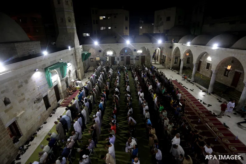 Palestinian Muslim worshippers pray overnight on July 2, 2016 at a Mosque in Gaza city on the occasion of Laylat al-Qadr which falls on the 27th day of the fasting month of Ramadan. Laylat al-Qadr, or Night of Destiny, m...