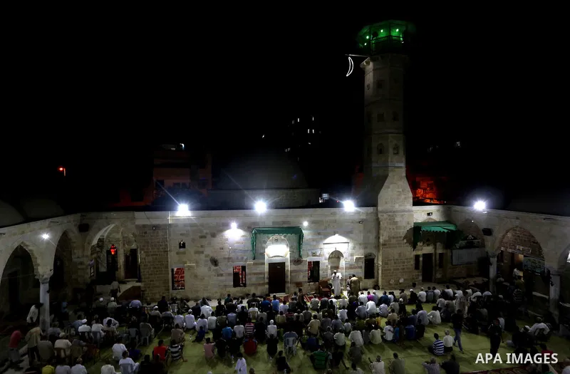 Palestinian Muslim worshippers pray overnight on July 2, 2016 at a Mosque in Gaza city on the occasion of Laylat al-Qadr which falls on the 27th day of the fasting month of Ramadan. Laylat al-Qadr, or Night of Destiny, m...