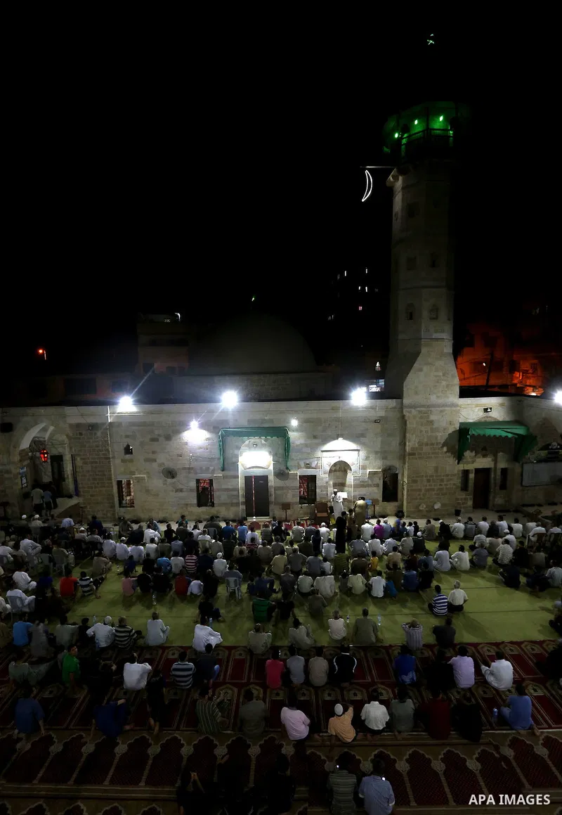 Palestinian Muslim worshippers pray overnight on July 2, 2016 at a Mosque in Gaza city on the occasion of Laylat al-Qadr which falls on the 27th day of the fasting month of Ramadan. Laylat al-Qadr, or Night of Destiny, m...