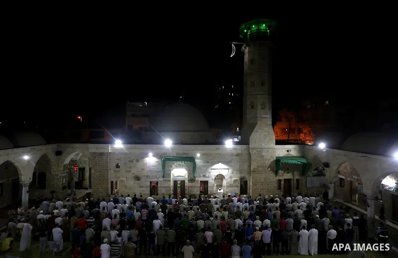 Palestinian Muslim worshippers pray overnight on July 2, 2016 at a Mosque in Gaza city on the occasion of Laylat al-Qadr which falls on the 27th day of the fasting month of Ramadan. Laylat al-Qadr, or Night of Destiny, m...